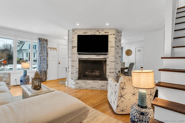 living room featuring a fireplace and light hardwood / wood-style flooring