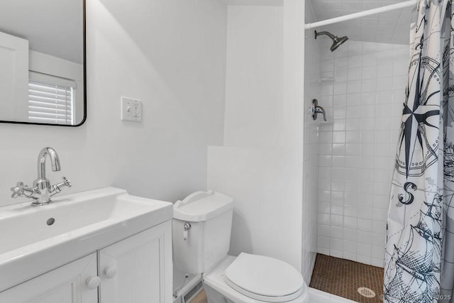 bathroom featuring toilet, vanity, and walk in shower