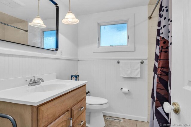 bathroom with vanity, a shower with curtain, tile patterned floors, and toilet