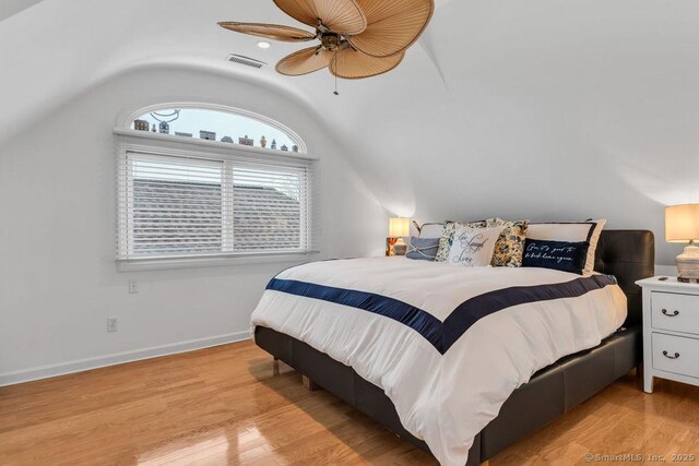 bedroom featuring lofted ceiling, light hardwood / wood-style floors, and ceiling fan