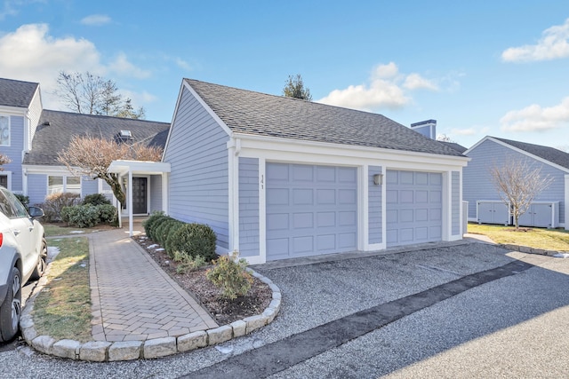 view of side of home featuring a garage