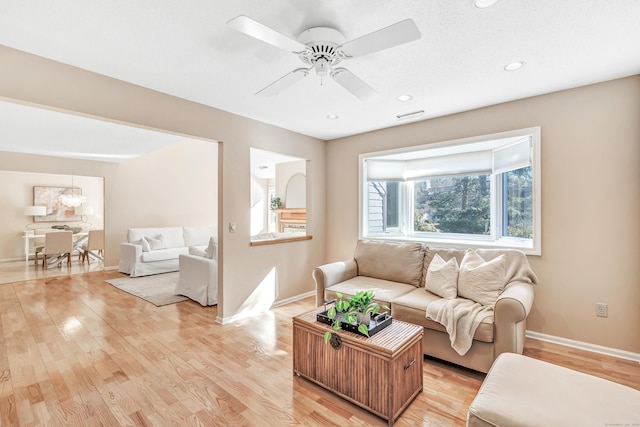 living room featuring ceiling fan and light wood-type flooring