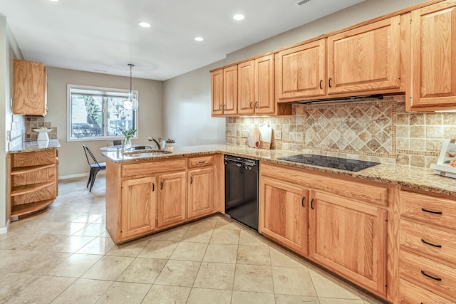 kitchen featuring decorative light fixtures, black appliances, sink, light tile patterned floors, and kitchen peninsula