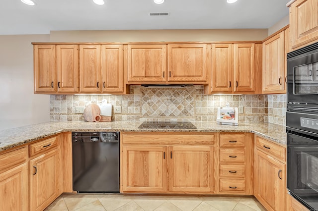 kitchen with backsplash, light stone countertops, black appliances, light tile patterned flooring, and light brown cabinetry