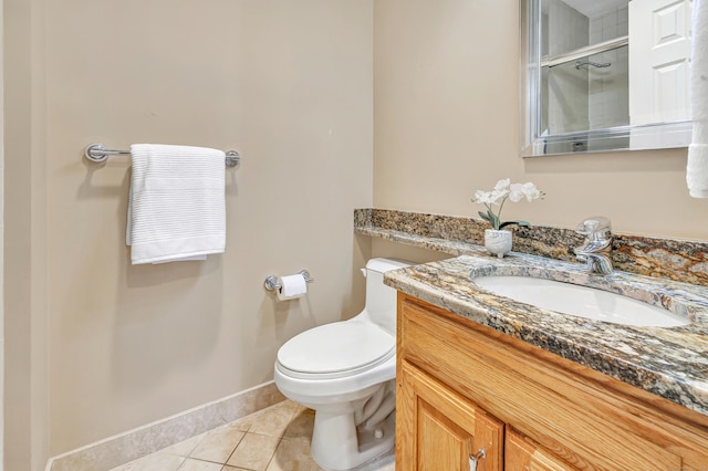 bathroom featuring vanity, walk in shower, tile patterned floors, and toilet