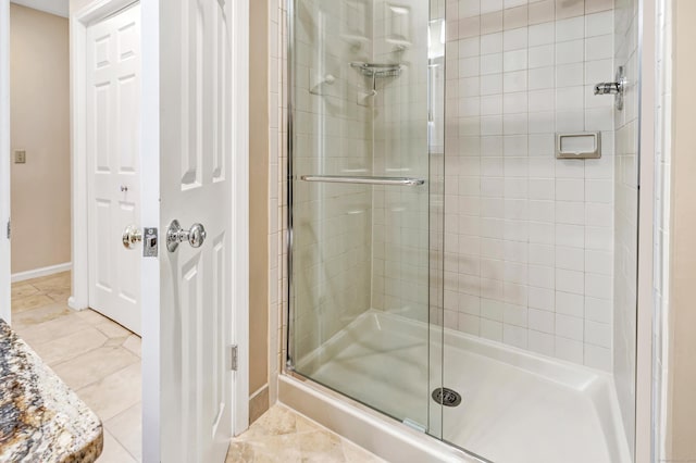 bathroom featuring a shower with door and tile patterned floors