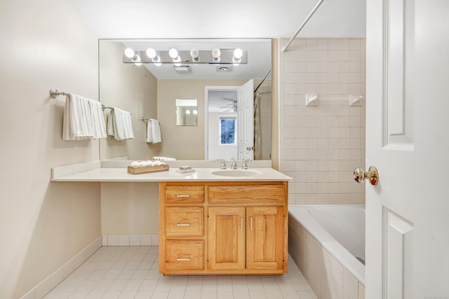 bathroom with vanity, tiled shower / bath combo, and tile patterned flooring