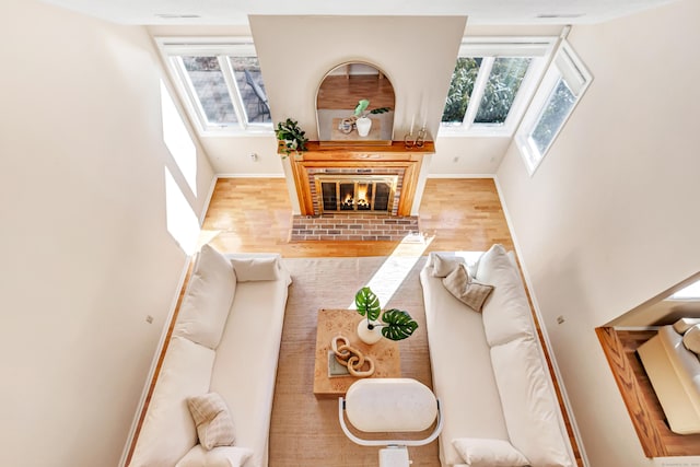 living room featuring hardwood / wood-style flooring, plenty of natural light, and a fireplace