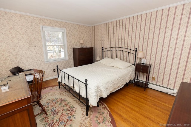 bedroom featuring ornamental molding and light hardwood / wood-style floors