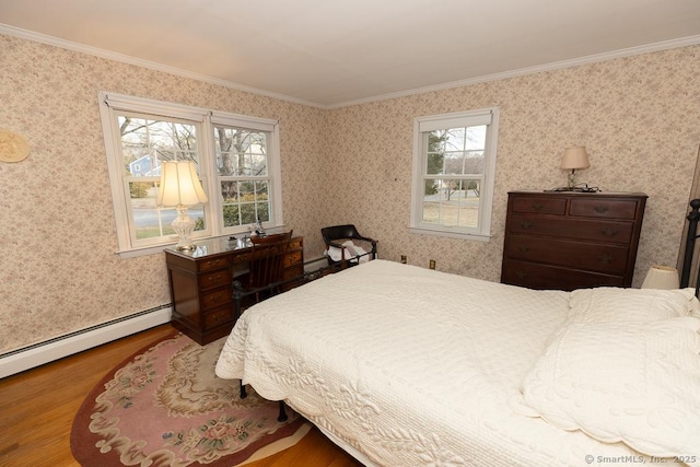 bedroom with hardwood / wood-style floors, ornamental molding, and baseboard heating