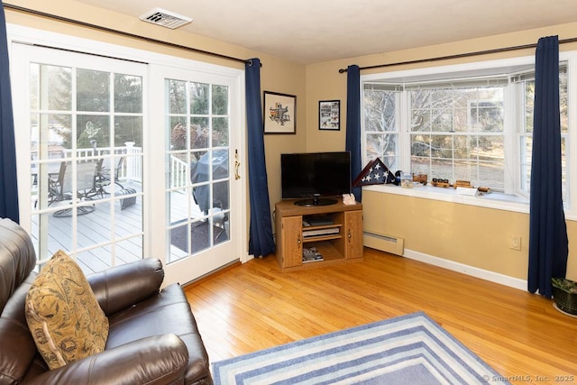 living room with a baseboard radiator and hardwood / wood-style floors