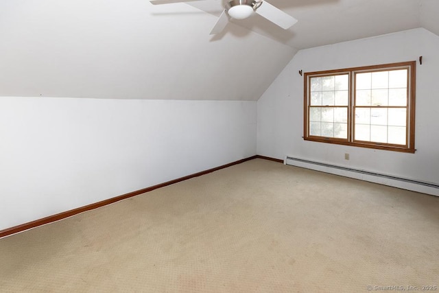 additional living space featuring baseboard heating, ceiling fan, lofted ceiling, and carpet