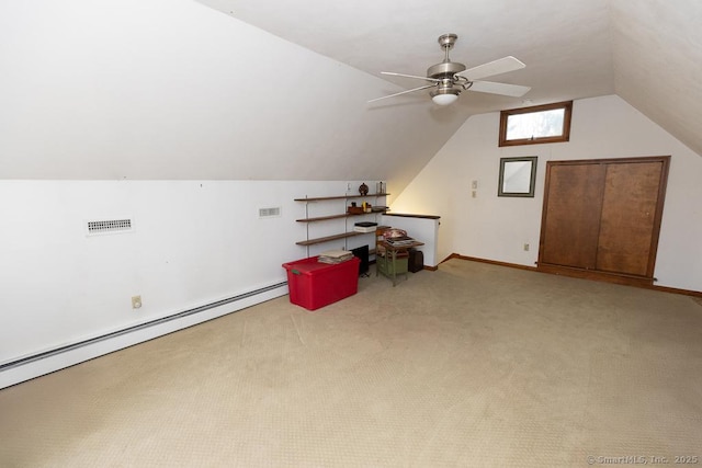 additional living space with ceiling fan, lofted ceiling, carpet, and baseboard heating