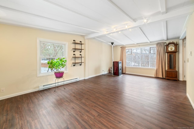 spare room featuring vaulted ceiling with beams, plenty of natural light, dark hardwood / wood-style flooring, and a baseboard heating unit