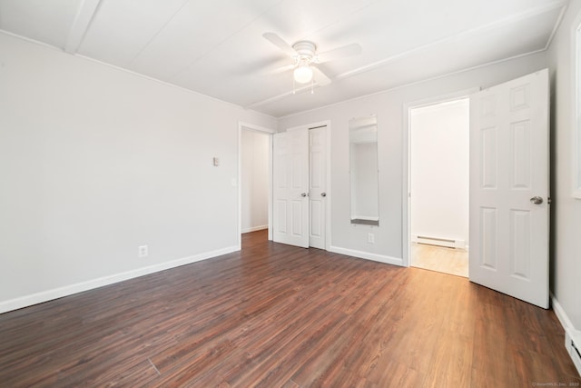 unfurnished bedroom featuring ceiling fan, dark hardwood / wood-style flooring, and a baseboard heating unit