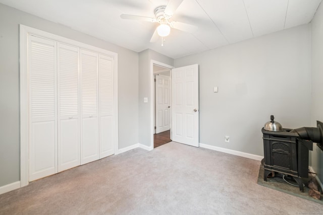 interior space featuring ceiling fan, carpet floors, and a closet