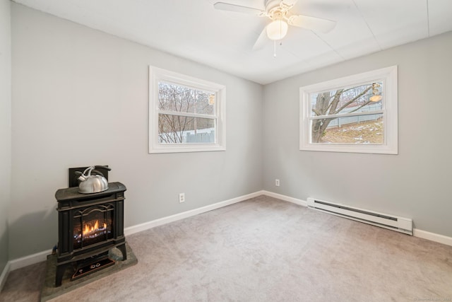 spare room featuring ceiling fan, a baseboard radiator, plenty of natural light, and carpet flooring