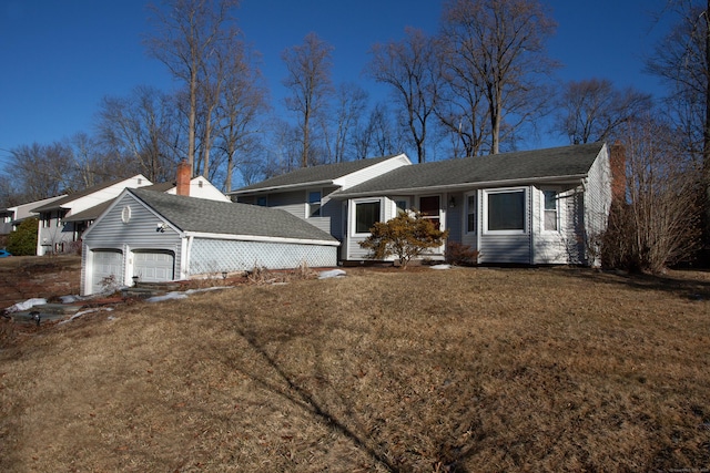 ranch-style house with a garage and a front lawn