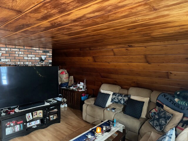 unfurnished living room with light hardwood / wood-style flooring, wood ceiling, and wood walls