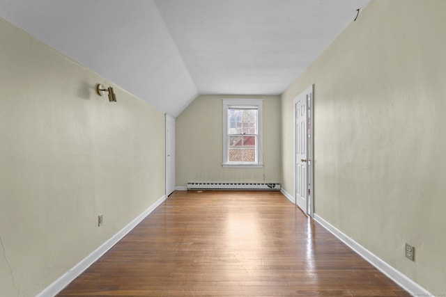 bonus room with vaulted ceiling, baseboard heating, wood finished floors, and baseboards