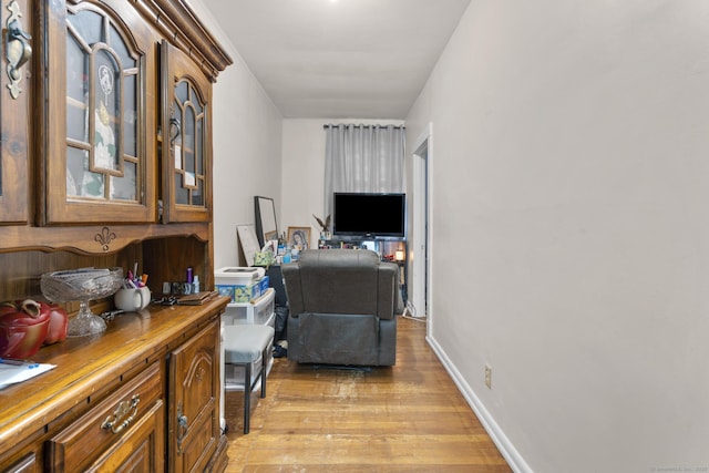 office space featuring light wood-type flooring and baseboards