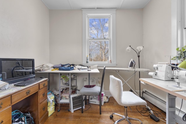 office space featuring baseboard heating and wood finished floors