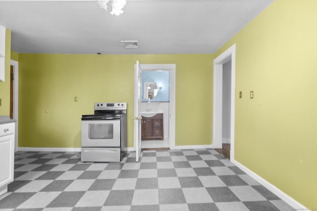 kitchen with visible vents, baseboards, white cabinetry, and stainless steel electric stove