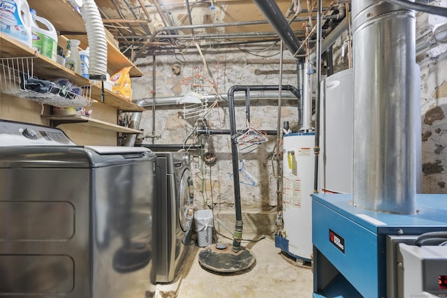 washroom featuring washing machine and dryer, laundry area, and water heater