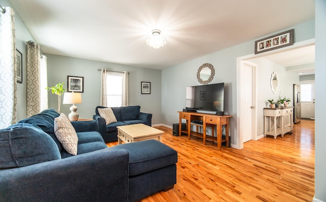 living room with plenty of natural light and light hardwood / wood-style floors