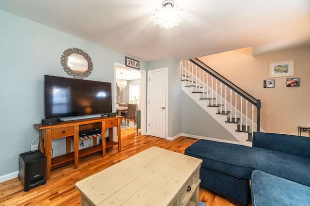 living room featuring a chandelier and light hardwood / wood-style floors