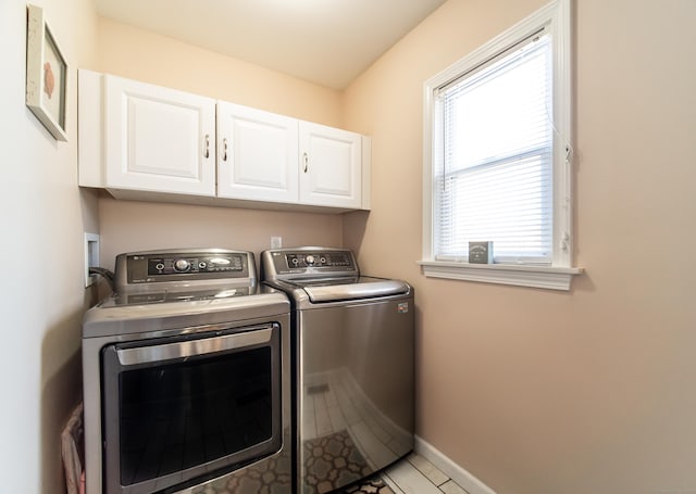 washroom featuring cabinets and independent washer and dryer