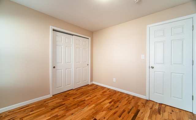 unfurnished bedroom featuring a closet and light hardwood / wood-style flooring