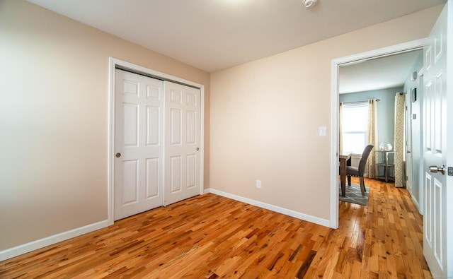 bedroom featuring light wood-type flooring and a closet