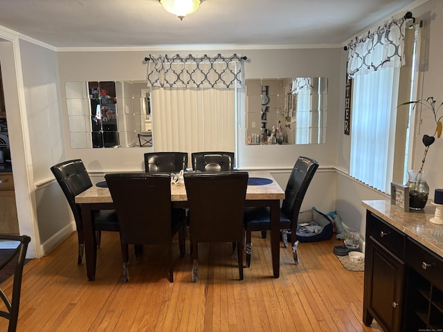 dining room featuring crown molding and light hardwood / wood-style floors