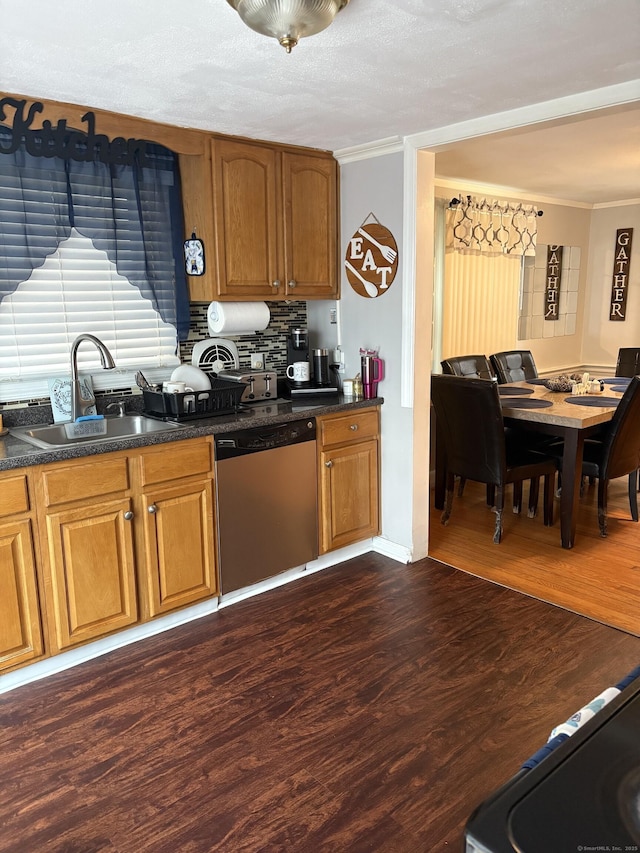 kitchen with stainless steel dishwasher, ornamental molding, dark hardwood / wood-style flooring, and sink