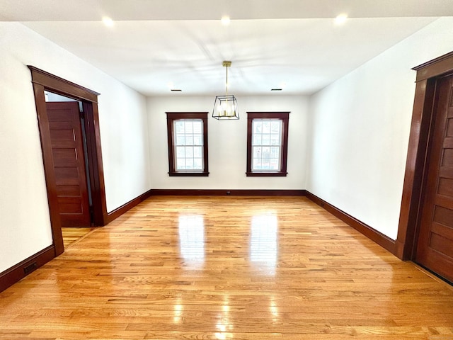 unfurnished dining area with light wood-type flooring