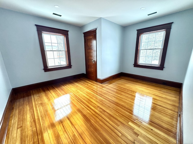 unfurnished bedroom featuring light hardwood / wood-style floors and a closet