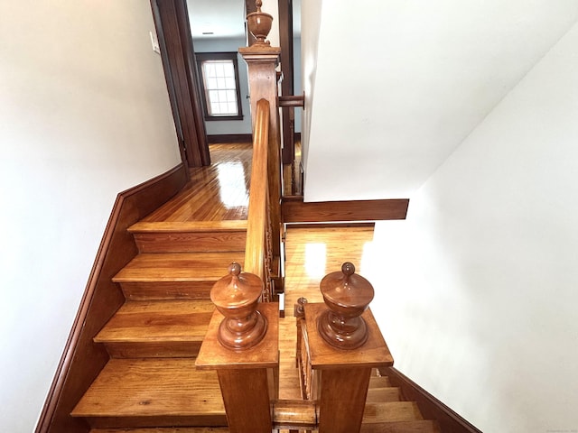 stairs featuring wood-type flooring