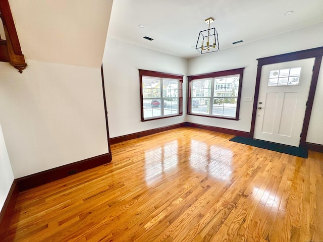 entrance foyer featuring a chandelier and light hardwood / wood-style flooring