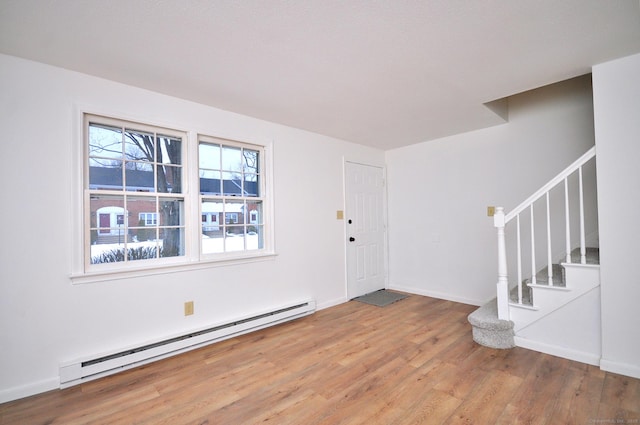 entrance foyer with hardwood / wood-style floors and baseboard heating