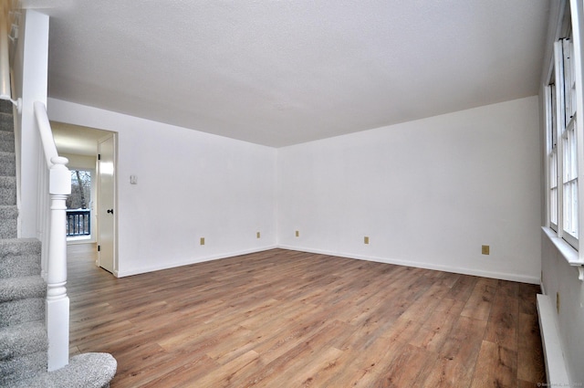 spare room with light hardwood / wood-style floors and a baseboard heating unit