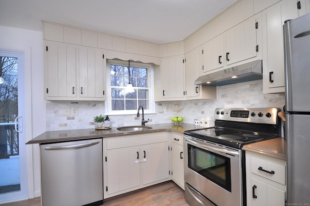 kitchen featuring white cabinetry, stainless steel appliances, and sink