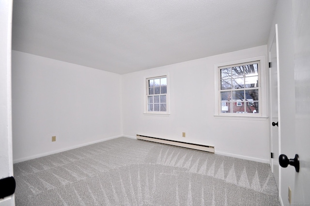 carpeted empty room with baseboard heating