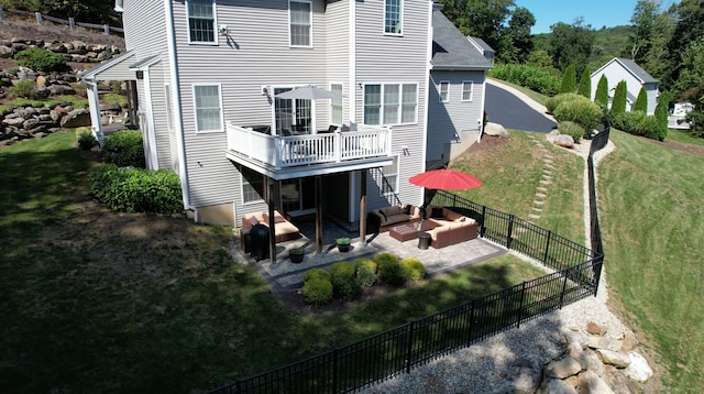 rear view of house featuring a balcony, a yard, an outdoor hangout area, and a patio