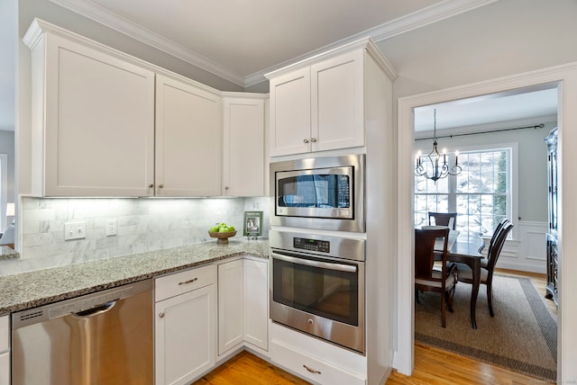 kitchen featuring light stone counters, white cabinets, and appliances with stainless steel finishes