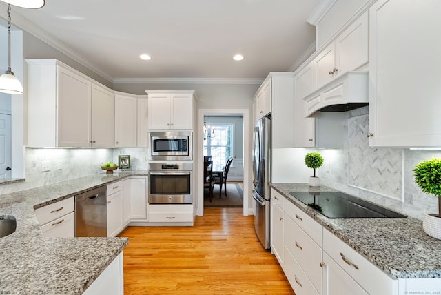 kitchen featuring light hardwood / wood-style flooring, hanging light fixtures, stainless steel appliances, ornamental molding, and white cabinets