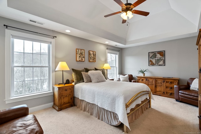 carpeted bedroom with lofted ceiling, ceiling fan, and a tray ceiling