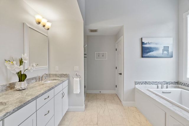 bathroom featuring vanity and a tub to relax in