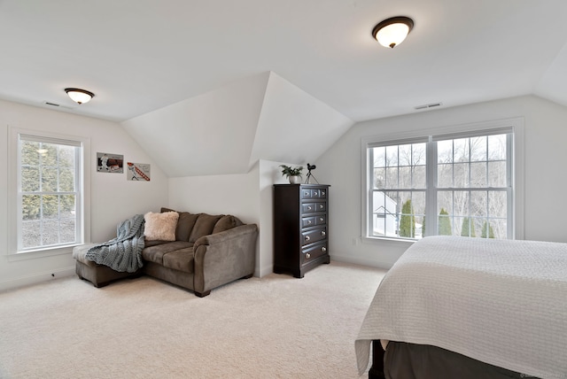 bedroom featuring lofted ceiling and light carpet