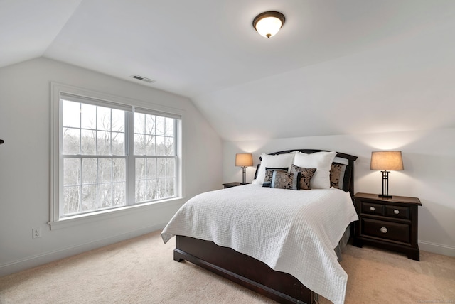 carpeted bedroom with lofted ceiling